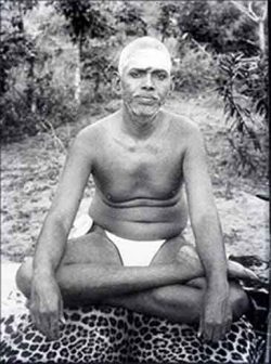 Ramana Maharashi, enlightened spiritual teacher, sitting on a tiger skin